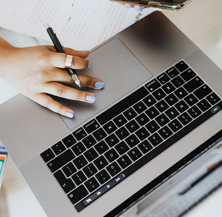 hand typing on a laptop